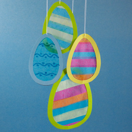 Egg-shaped suncatchers made with strips of tissue paper