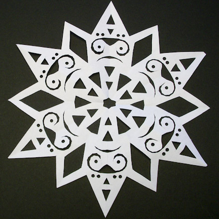 Fancy snowflake made with hole punch.
