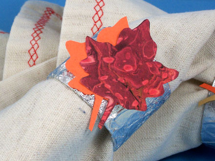 Napkin ring with leaf cut from marbled paper