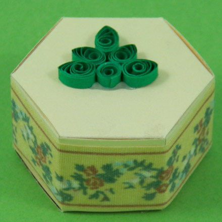 Hexagon box decorated with ribbon and quilling
