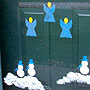 Window stenciled with angels and snowmen