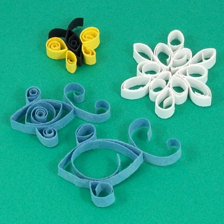Quilled designs made with construction paper strips