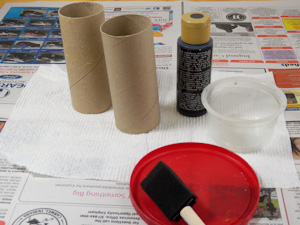 Paint empty cardboard tube with black paint