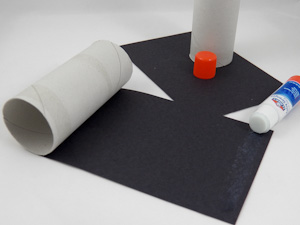 Cover cardboard tubes with black construction paper