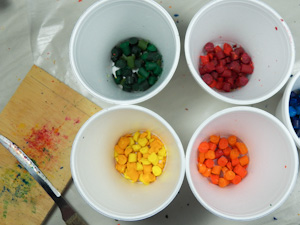 Cut crayons to pea-size