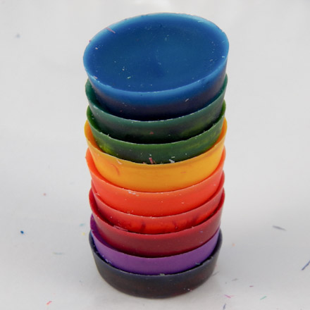Multi-colored stack of recycled crayons