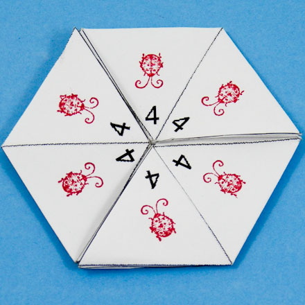Numbered hexa-hexaflexagon decorated with rubber stamps
