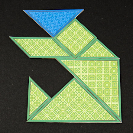 Tangram bear made of puzzle pieces from two tangram sets