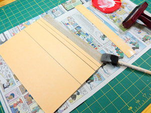 Glue posterboard strips to base