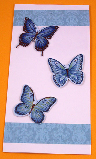 Recycled card made with fussy-cut butterflys and borders cut from same card front